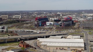 DX0002_116_041 - 5.7K aerial stock footage slowly flying away from Nissan Stadium near bridge in Nashville, Tennessee