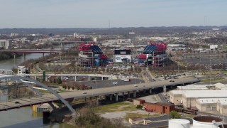 DX0002_116_044 - 5.7K aerial stock footage approach Nissan Stadium while descending near the bridge in Nashville, Tennessee