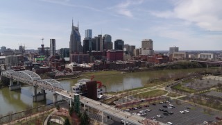 DX0002_117_002 - 5.7K aerial stock footage of the city's riverfront skyscrapers seen from the pedestrian bridge, Downtown Nashville, Tennessee