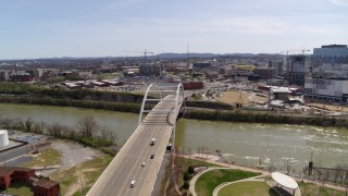 DX0002_117_017 - 5.7K aerial stock footage ascend and orbit the Korean War Veterans Memorial Bridge as cars cross in Nashville, Tennessee