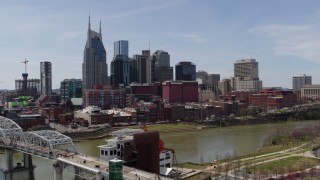 DX0002_117_022 - 5.7K aerial stock footage flying by the city's skyline overlooking the Cumberland River, Downtown Nashville, Tennessee