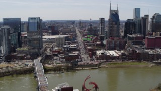 DX0002_117_030 - 5.7K aerial stock footage busy Broadway across the Cumberland River, Downtown Nashville, Tennessee
