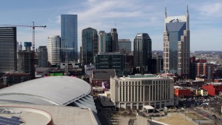 DX0002_117_049 - 5.7K aerial stock footage of flying past the city's skyline and Hilton hotel, Downtown Nashville, Tennessee