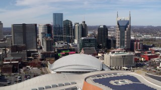 DX0002_117_051 - 5.7K aerial stock footage fly away from and past the city's skyline, Bridgestone Arena, and Hilton hotel, Downtown Nashville, Tennessee