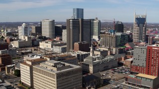 DX0002_118_008 - 5.7K aerial stock footage of a reverse view of a high-rise hotel and skyscrapers in Downtown Nashville, Tennessee
