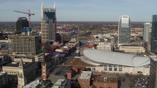 DX0002_119_007 - 5.7K aerial stock footage flyby top of hotel to reveal Broadway and Bridgestone Arena in Downtown Nashville, Tennessee