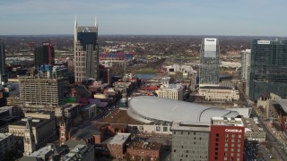 DX0002_119_012 - 5.7K aerial stock footage reverse view of AT&T Building, Broadway, Bridgestone Arena, Pinnacle skyscraper, Downtown Nashville, Tennessee