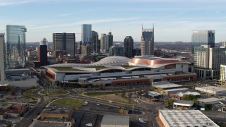 DX0002_119_028 - 5.7K aerial stock footage fly away from and pass Nashville Music City Center and city's skyline, Downtown Nashville, Tennessee