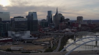 DX0002_119_036 - 5.7K aerial stock footage of the AT&T Building and city skyscrapers at sunset, Downtown Nashville, Tennessee