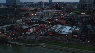 DX0002_120_022 - 5.7K aerial stock footage of a reverse view of Broadway during ascent at twilight, Downtown Nashville, Tennessee