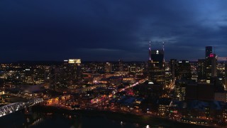 DX0002_121_008 - 5.7K aerial stock footage fly away from Pinnacle skyscraper and AT&T Building for view of Broadway at twilight, Downtown Nashville, Tennessee