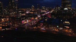 DX0002_121_019 - 5.7K aerial stock footage of flying toward Broadway and traffic at twilight, Downtown Nashville, Tennessee