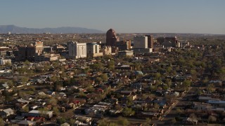 DX0002_122_004 - 5.7K stock footage aerial video of flying by the city's high-rises seen from neighborhoods during descent, Downtown Albuquerque, New Mexico