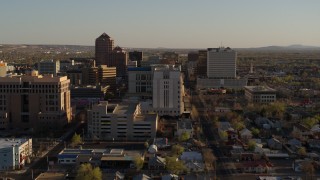 DX0002_122_021 - 5.7K aerial stock footage of flying by a courthouse and office high-rise buildings in Downtown Albuquerque, New Mexico