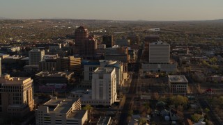 DX0002_122_024 - 5.7K aerial stock footage of flying by office high-rise buildings behind courthouse in Downtown Albuquerque, New Mexico