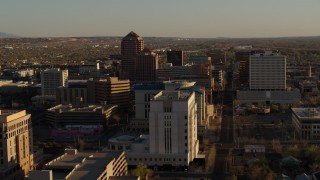 DX0002_122_030 - 5.7K stock footage aerial video descend near courthouse, fly away from office high-rises in Downtown Albuquerque, New Mexico