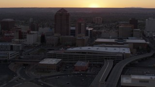 DX0002_122_052 - 5.7K aerial stock footage orbit office tower and shorter hotel tower behind convention center at sunset, Downtown Albuquerque, New Mexico
