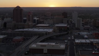 DX0002_122_053 - 5.7K aerial stock footage flyby office tower and shorter hotel tower behind convention center at sunset, Downtown Albuquerque, New Mexico