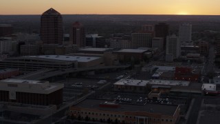 DX0002_122_054 - 5.7K aerial stock footage flyby office high-rises and convention center near office tower and shorter hotel tower at sunset, Downtown Albuquerque, New Mexico