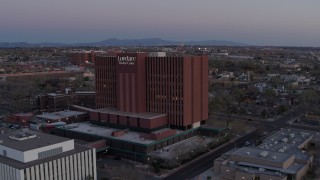 DX0002_123_001 - 5.7K aerial stock footage of approaching a hospital at sunset in Albuquerque, New Mexico