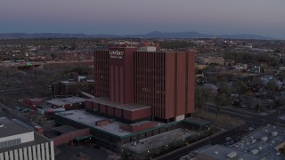 DX0002_123_002 - 5.7K stock footage aerial video of a reverse view of a hospital at sunset in Albuquerque, New Mexico