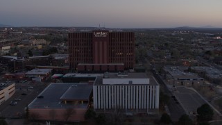 DX0002_123_003 - 5.7K aerial stock footage of orbiting a hospital at sunset in Albuquerque, New Mexico