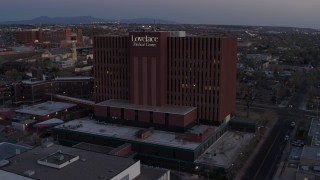 DX0002_123_004 - 5.7K aerial stock footage of an orbit of a hospital at sunset in Albuquerque, New Mexico