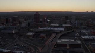 DX0002_123_007 - 5.7K aerial stock footage approach and pass Albuquerque Plaza and Hyatt Regency at sunset near office high-rises, Downtown Albuquerque, New Mexico