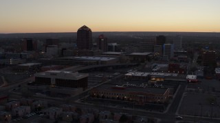 DX0002_123_009 - 5.7K aerial stock footage passing Albuquerque Plaza and Hyatt Regency at sunset near office high-rises, Downtown Albuquerque, New Mexico
