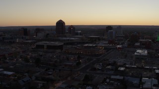 DX0002_123_011 - 5.7K aerial stock footage approach Albuquerque Plaza and Hyatt Regency at sunset, Downtown Albuquerque, New Mexico