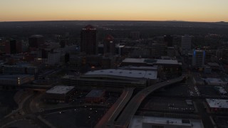 DX0002_123_012 - 5.7K aerial stock footage flyby and way from Albuquerque Plaza and Hyatt Regency at sunset, Downtown Albuquerque, New Mexico