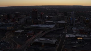 DX0002_123_013 - 5.7K aerial stock footage orbiting Albuquerque Plaza and Hyatt Regency at sunset, Downtown Albuquerque, New Mexico