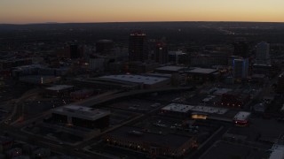 DX0002_123_014 - 5.7K aerial stock footage orbit Albuquerque Plaza and Hyatt Regency at sunset, Downtown Albuquerque, New Mexico
