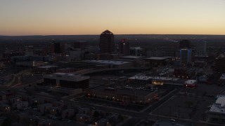 DX0002_123_015 - 5.7K aerial stock footage passing Albuquerque Plaza and Hyatt Regency at sunset, Downtown Albuquerque, New Mexico