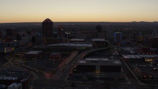 DX0002_123_016 - 5.7K stock footage aerial video flying by Albuquerque Plaza, Hyatt Regency and city high-rises at sunset, Downtown Albuquerque, New Mexico