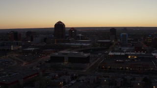 DX0002_123_017 - 5.7K aerial stock footage of a wide orbit of Albuquerque Plaza, Hyatt Regency and city high-rises at sunset, Downtown Albuquerque, New Mexico