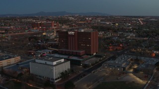 DX0002_123_018 - 5.7K aerial stock footage of a reverse view of a hospital at twilight in Albuquerque, New Mexico