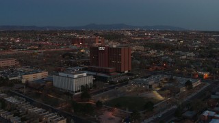 DX0002_123_019 - 5.7K aerial stock footage fly toward and orbit a hospital at twilight in Albuquerque, New Mexico
