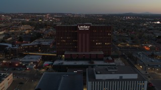 DX0002_123_020 - 5.7K aerial stock footage of circling a hospital at twilight in Albuquerque, New Mexico