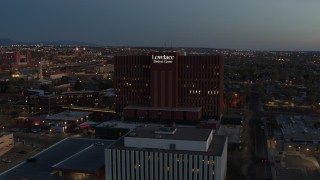 DX0002_123_022 - 5.7K aerial stock footage approach a hospital building at twilight in Albuquerque, New Mexico