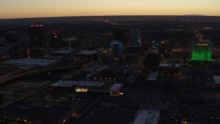 DX0002_123_025 - 5.7K aerial stock footage flyby hotel and nearby office buildings at twilight, Downtown Albuquerque, New Mexico