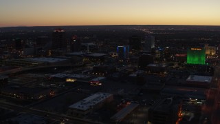 DX0002_123_026 - 5.7K aerial stock footage of hotel and office buildings at twilight, Downtown Albuquerque, New Mexico
