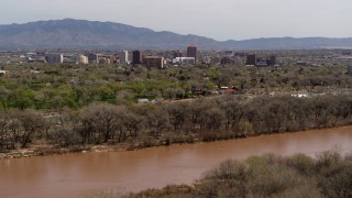 DX0002_124_001 - 5.7K aerial stock footage of high-rise office buildings seen from the Rio Grande, Downtown Albuquerque, New Mexico