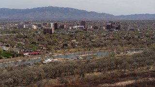 DX0002_124_010 - 5.7K stock footage aerial video of high-rise office buildings seen from Tingley Beach, Downtown Albuquerque, New Mexico