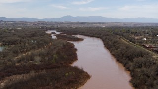 DX0002_124_012 - 5.7K aerial stock footage of flying over the Rio Grande, approach small islands in the river in Albuquerque, New Mexico