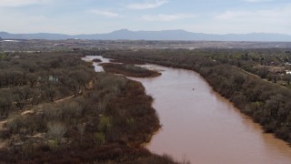 DX0002_124_013 - 5.7K aerial stock footage of flying away from islands in the Rio Grande river in Albuquerque, New Mexico