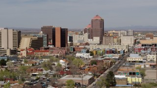 DX0002_124_027 - 5.7K aerial stock footage fly away from and by Albuquerque Plaza office high-rise and surrounding buildings, Downtown Albuquerque, New Mexico
