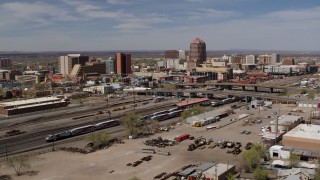 DX0002_124_029 - 5.7K aerial stock footage passing railroad tracks with view of Albuquerque Plaza and surrounding buildings, Downtown Albuquerque, New Mexico