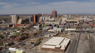 DX0002_124_030 - 5.7K aerial stock footage flyby train tracks, focus on Albuquerque Plaza and surrounding buildings, Downtown Albuquerque, New Mexico
