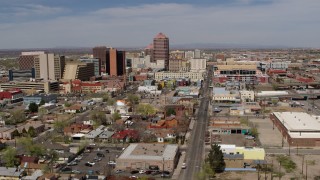 DX0002_124_031 - 5.7K stock footage aerial video flyby and away from Albuquerque Plaza and surrounding buildings, Downtown Albuquerque, New Mexico
